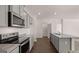 This modern kitchen features stainless appliances, granite countertops, and island at 162 Aster Ave, Locust Grove, GA 30248