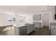 New kitchen with granite countertops, stainless appliances, and a central island at 162 Aster Ave, Locust Grove, GA 30248