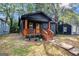 Charming home features a black exterior, wooden porch, and a well-maintained front yard at 1336 Mcclelland Ave, Atlanta, GA 30344
