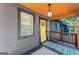 Inviting porch with a stylish yellow door and modern lighting fixture at 1336 Mcclelland Ave, Atlanta, GA 30344