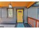 Inviting front porch with a stylish yellow door and modern lighting fixture at 1336 Mcclelland Ave, Atlanta, GA 30344