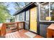 Charming home exterior features a wood deck and yellow front door at 1336 Mcclelland Ave, Atlanta, GA 30344