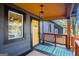 Inviting front porch with a yellow door, blue patterned rug, and rustic wooden railing at 1336 Mcclelland Ave, Atlanta, GA 30344