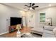 Stylish living room featuring a ceiling fan, wood floors, sectional couch, and natural light at 1336 Mcclelland Ave, Atlanta, GA 30344