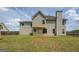 Back exterior featuring a light colored siding, large chimney and an expansive backyard with grass at 823 Hennepin Ter, Mcdonough, GA 30253