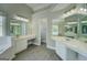 Bright bathroom features white cabinets, dual sinks, wood-look floors, and a separate shower and tub at 823 Hennepin Ter, Mcdonough, GA 30253