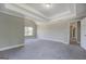 Bright bedroom featuring high ceilings, neutral walls, a window and gray carpet at 823 Hennepin Ter, Mcdonough, GA 30253