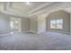 Empty main bedroom featuring high ceilings, neutral walls, a window and gray carpet at 823 Hennepin Ter, Mcdonough, GA 30253