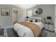 Stylized bedroom featuring modern décor, neutral tones, and an ensuite bathroom at 823 Hennepin Ter, Mcdonough, GA 30253