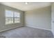 Bright bedroom with a large window offering natural light and a view of the outdoors at 823 Hennepin Ter, Mcdonough, GA 30253
