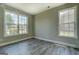 Bright bedroom features hardwood floors and two large windows for ample natural light at 823 Hennepin Ter, Mcdonough, GA 30253