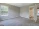Cozy bedroom with neutral walls and large window, offering a glimpse into the ensuite bathroom at 823 Hennepin Ter, Mcdonough, GA 30253