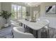 Bright dining room features a modern chandelier and large windows at 823 Hennepin Ter, Mcdonough, GA 30253