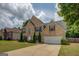 Charming two-story home features a brick facade, arched windows, and a well-maintained lawn at 823 Hennepin Ter, Mcdonough, GA 30253