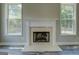 Cozy fireplace with white mantel between two windows adds charm to the living space at 823 Hennepin Ter, Mcdonough, GA 30253