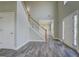 Inviting foyer featuring soaring ceilings, wood-look floors, a staircase, and a view into the living room at 823 Hennepin Ter, Mcdonough, GA 30253