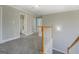 Upstairs hallway with wood railing and access to bathroom at 823 Hennepin Ter, Mcdonough, GA 30253