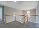 Hallway with gray carpet, white rails, light-colored walls and an arched window at 823 Hennepin Ter, Mcdonough, GA 30253