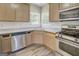 Kitchen with stainless steel appliances, granite countertops, new flooring, and abundant natural light at 823 Hennepin Ter, Mcdonough, GA 30253