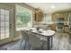 Eat-in kitchen with modern lighting fixtures, stainless steel appliances, and bright view to the backyard at 823 Hennepin Ter, Mcdonough, GA 30253