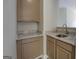 Cozy kitchenette with sink, granite countertop, and ample cabinet space at 823 Hennepin Ter, Mcdonough, GA 30253