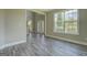 Living room featuring wood-look floors, neutral walls, and a doorway to the foyer at 823 Hennepin Ter, Mcdonough, GA 30253