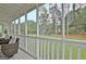Backyard view showcasing the expansive lawn, mature trees, and inviting outdoor seating area at 207 Tiverton Trl, Peachtree City, GA 30269