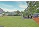 Expansive backyard with a fire pit area and a well-maintained lawn, ideal for outdoor entertaining at 207 Tiverton Trl, Peachtree City, GA 30269
