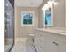 Elegant bathroom showcasing a double vanity with quartz counters and tiled shower at 207 Tiverton Trl, Peachtree City, GA 30269