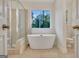 Luxurious bathroom with a modern tub, frameless shower, and elegant fixtures at 207 Tiverton Trl, Peachtree City, GA 30269