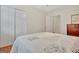 Bright bedroom with a bed, closet and wood-look laminate flooring at 207 Tiverton Trl, Peachtree City, GA 30269