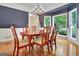 Elegant dining room with hardwood floors, modern chandelier, and bright natural light at 207 Tiverton Trl, Peachtree City, GA 30269