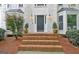 Inviting home entrance with brick steps, manicured shrubbery, and elegant exterior lighting at 207 Tiverton Trl, Peachtree City, GA 30269