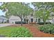 Beautiful two-story home featuring lush landscaping, brick accents, and an attached garage at 207 Tiverton Trl, Peachtree City, GA 30269
