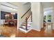 Bright foyer with hardwood floors, staircase, and views into the dining and living areas at 207 Tiverton Trl, Peachtree City, GA 30269