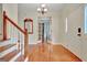 Inviting foyer with hardwood floors, staircase, and view through french doors at 207 Tiverton Trl, Peachtree City, GA 30269