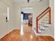 Inviting foyer with hardwood floors, staircase, and a glimpse into the dining area at 207 Tiverton Trl, Peachtree City, GA 30269