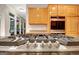 Close-up of a high-end gas cooktop with stainless steel knobs, set against a backdrop of wooden cabinetry at 207 Tiverton Trl, Peachtree City, GA 30269