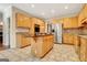 Spacious kitchen featuring ample cabinet space, a central island with cooktop, and stainless steel appliances at 207 Tiverton Trl, Peachtree City, GA 30269