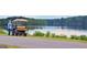 Scenic view of Lake Peachtree with a golf cart parked alongside the water, offering a relaxing lakeside experience at 207 Tiverton Trl, Peachtree City, GA 30269