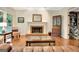 Inviting living room with hardwood floors, fireplace, and built-in cabinetry at 207 Tiverton Trl, Peachtree City, GA 30269