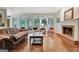Spacious living room with fireplace, hardwood floors, and access to outdoor patio at 207 Tiverton Trl, Peachtree City, GA 30269