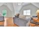 Cozy living room featuring vaulted ceilings, hardwood floors, and comfortable seating with natural light at 207 Tiverton Trl, Peachtree City, GA 30269
