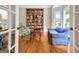 Cozy living room with built-in bookcase, hardwood floors, and large bay window at 207 Tiverton Trl, Peachtree City, GA 30269