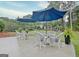 Outdoor patio with white wicker chairs and blue umbrellas, perfect for relaxation at 207 Tiverton Trl, Peachtree City, GA 30269
