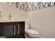 Chic half bathroom featuring designer wallpaper, elegant fixtures, and refined detailing at 207 Tiverton Trl, Peachtree City, GA 30269
