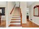 Traditional staircase with wood treads and railing leading to the upper level of the home at 207 Tiverton Trl, Peachtree City, GA 30269