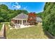 Expansive backyard featuring lush grass, mature trees, patio seating, and a screened porch attached to the house at 273 Prominent Loop, Mcdonough, GA 30253