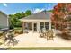 Backyard patio with a grill, dining table, seating, and a screened porch with a view of the home at 273 Prominent Loop, Mcdonough, GA 30253