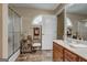 Bright bathroom with tile floors, shower stall, and a single sink vanity with storage space at 273 Prominent Loop, Mcdonough, GA 30253